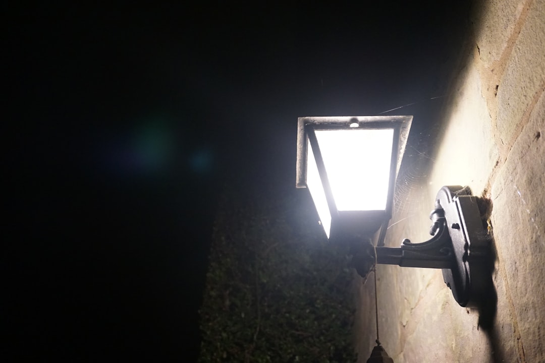 A bright security light illuminates a wall at night