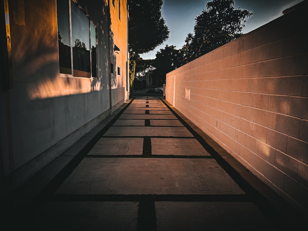 A narrow pathway between two walls at sunset