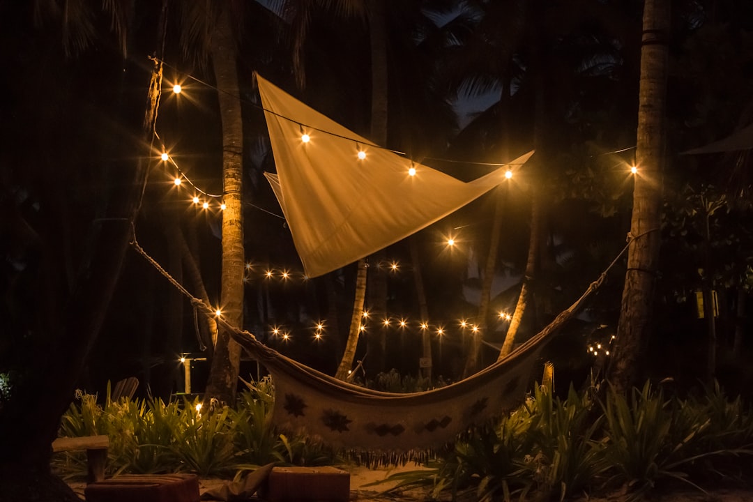 Hammock with string lights and a sail at night